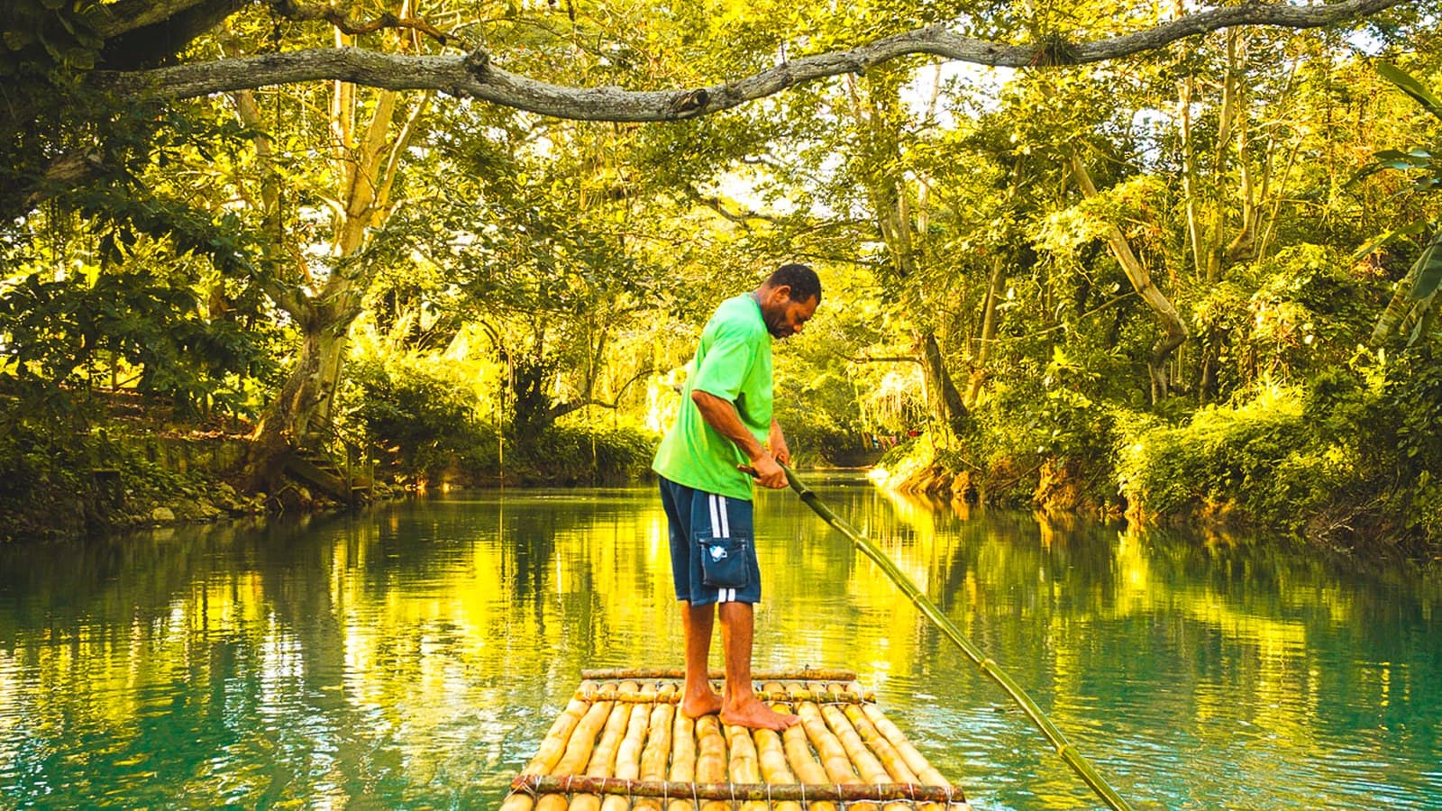 A raftsman poling a bamboo raft on the Martha Brae River in Trelawny
