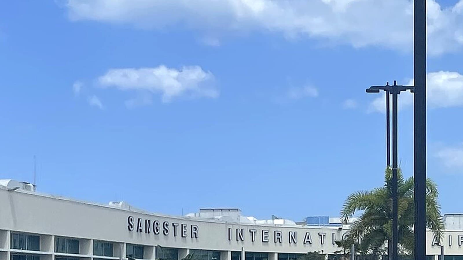 Sangster International lettering on the MBJ terminal, where a reunion meets one name-sign